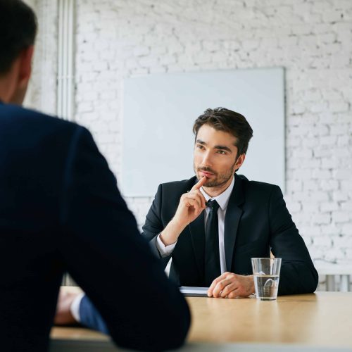 Two businessmen talking during job interview